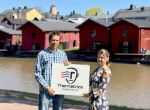 Picture of Aki and Kristin with thermetrics logo sign
