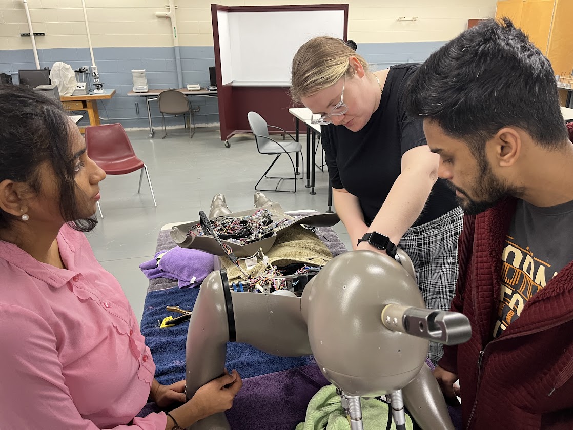 Picture of Lauren Agnew, Laboratory Coordinator and Instructor of Fashion, Interior Design & Merchandising plus two students working on one of the thermal manikins in their test lab.
